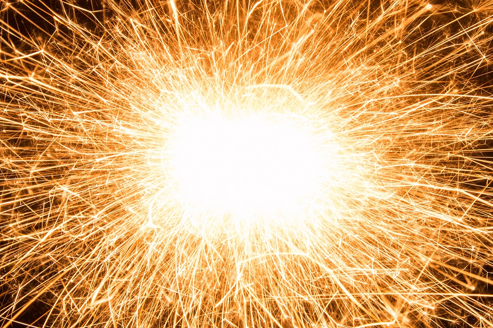 Bright burst of orange light with lines coming out of it.